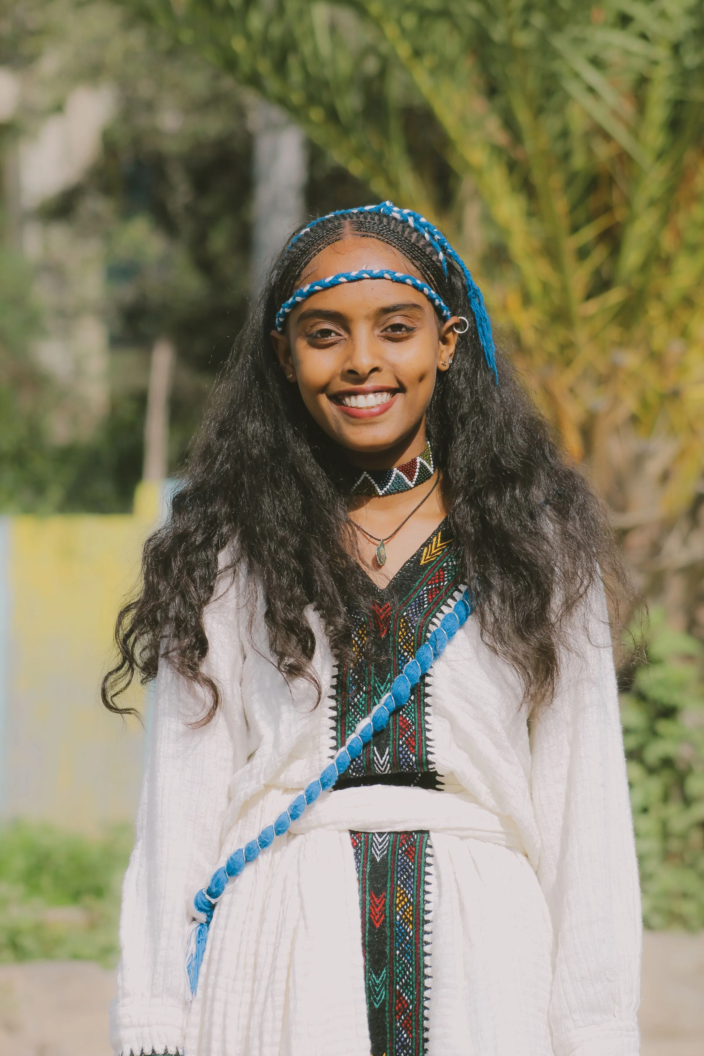 Smiling young woman in traditional Ethiopian dress in Addis Ababa